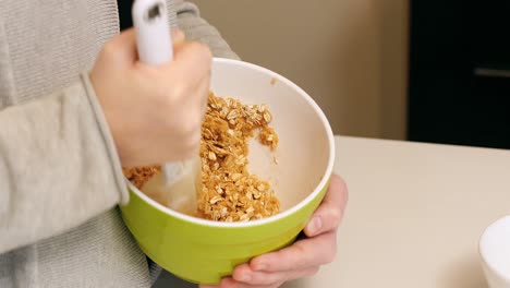 woman mixing ingredients to bowl for baking