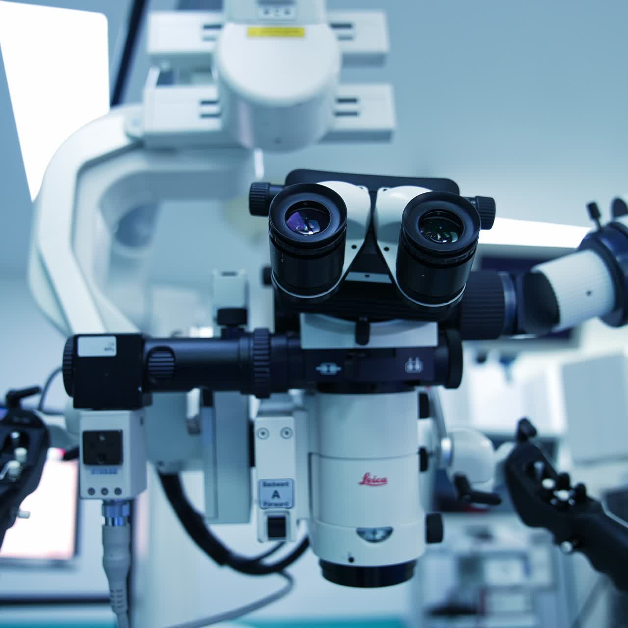 Closer look at the binoculars of powerful microscope in surgery room. Advanced equipment for modern surgical operations. Low angle view close up