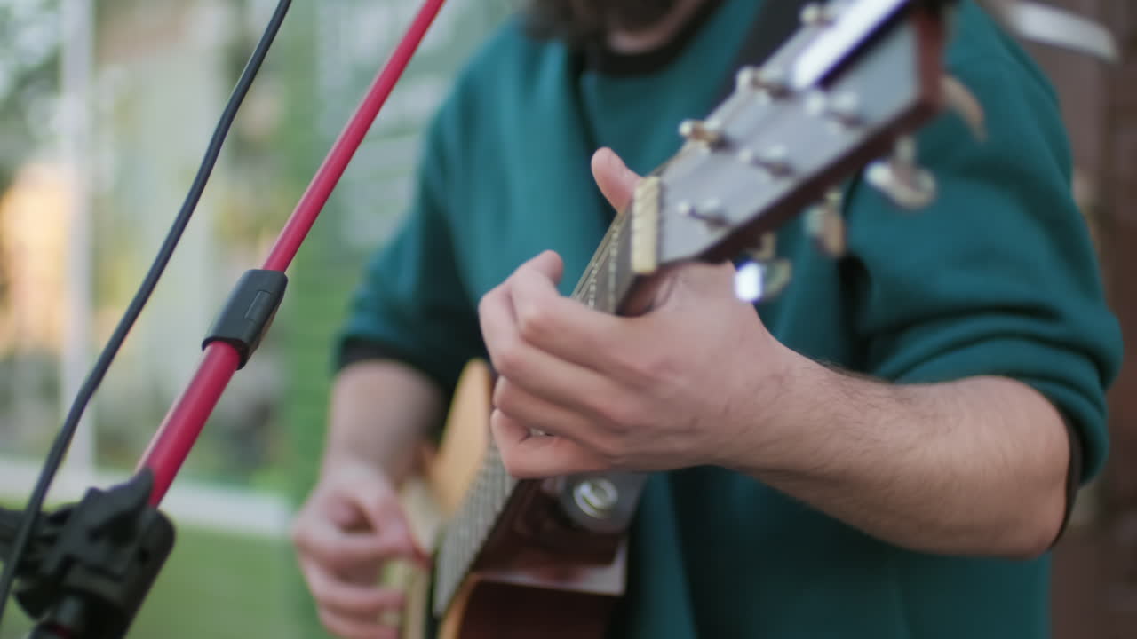 Happy Male Musician Singing and Playing Guitar Outside