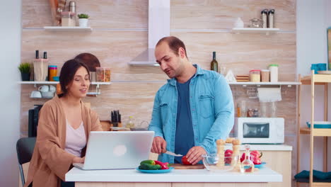 married couple watching online recipe