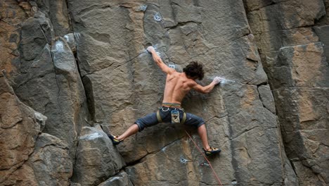 a daring climber showcases exceptional strength and skill as they ascend a challenging rock face, demonstrating the thrill of outdoor sport and personal achievement.