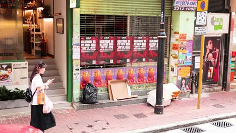 pedestrians pass by a colorful storefront