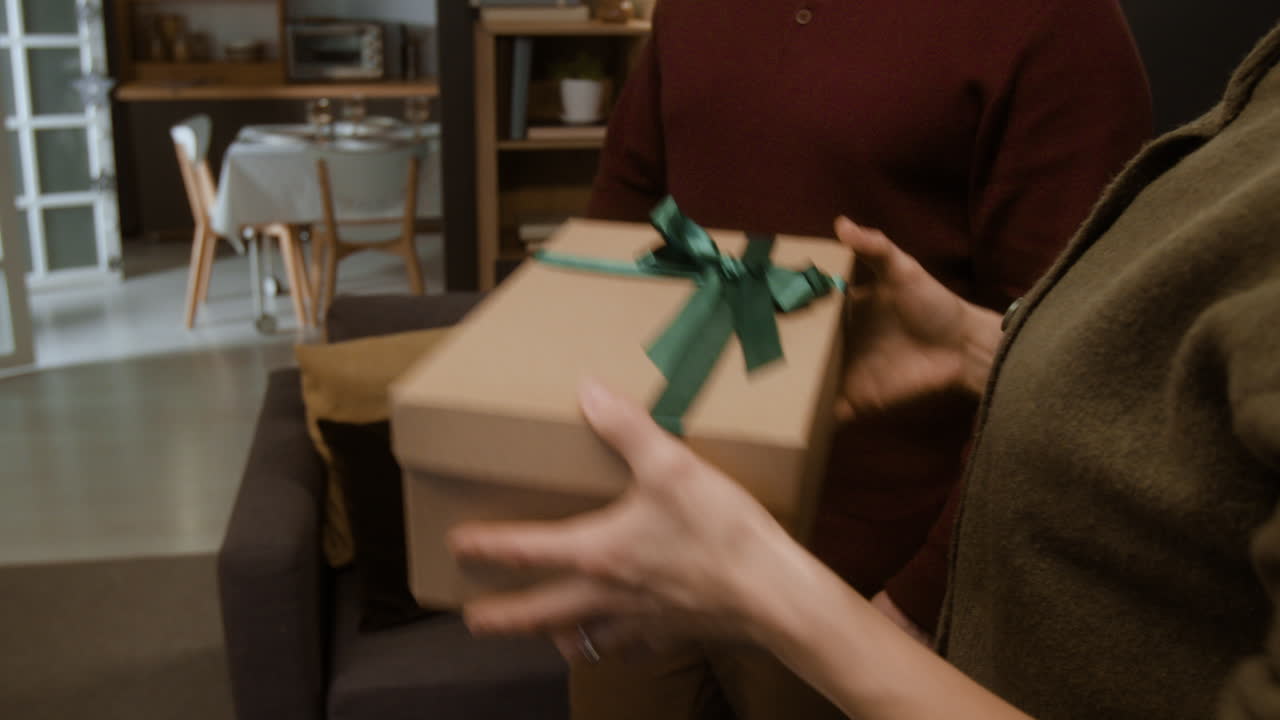 Senior woman gives a gift to family