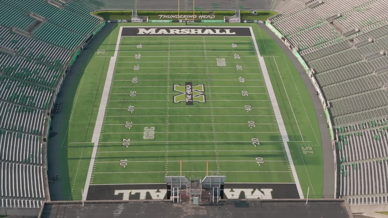Aerial video Marshall University football field Joan C. Edwards Stadium in and down from side.