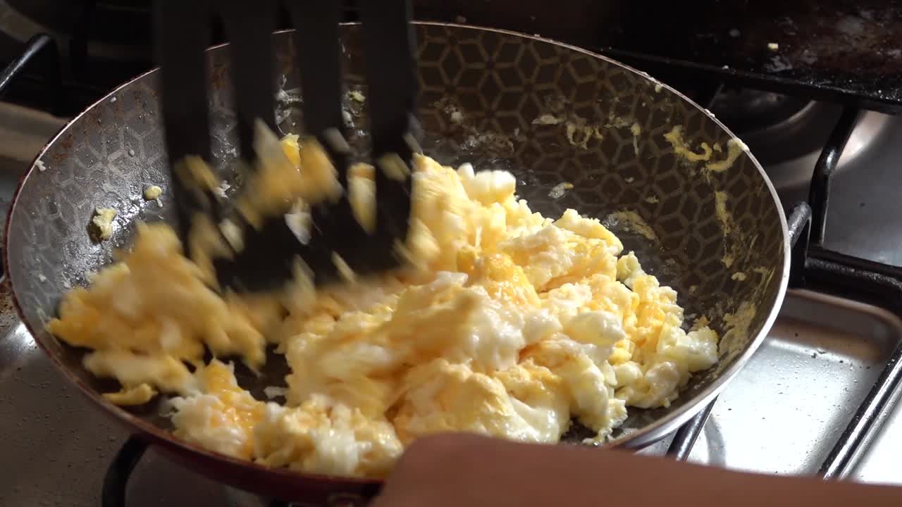 Scrambled eggs cooked on a frying pan