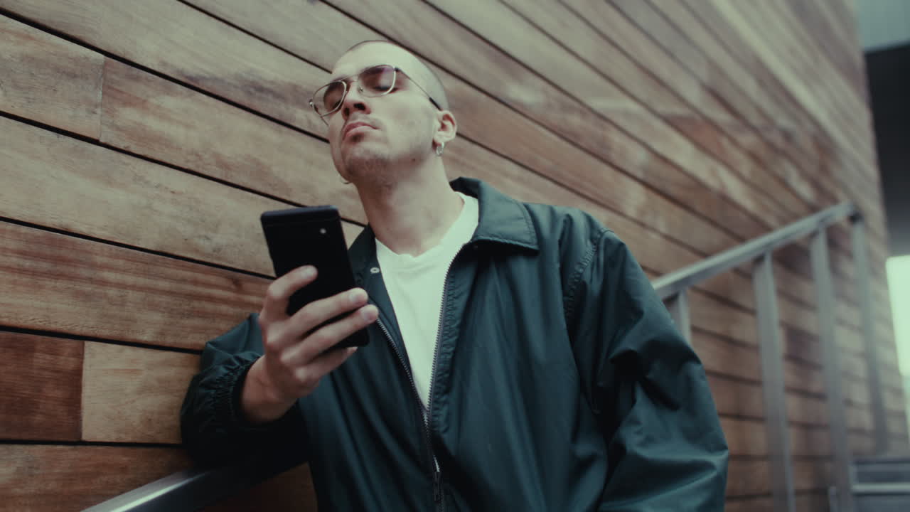 Man looking at smartphone on stairs