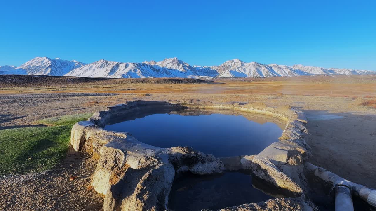 Winter early morning blue sky natural Hilltop Whitmore Wild Willys Hot Springs hot tub soak sunny sky snow covered Mammoth Mountain Minarets aerial drone Convict Canyon peaceful steam forward