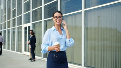 businesswoman talking on phone and walking