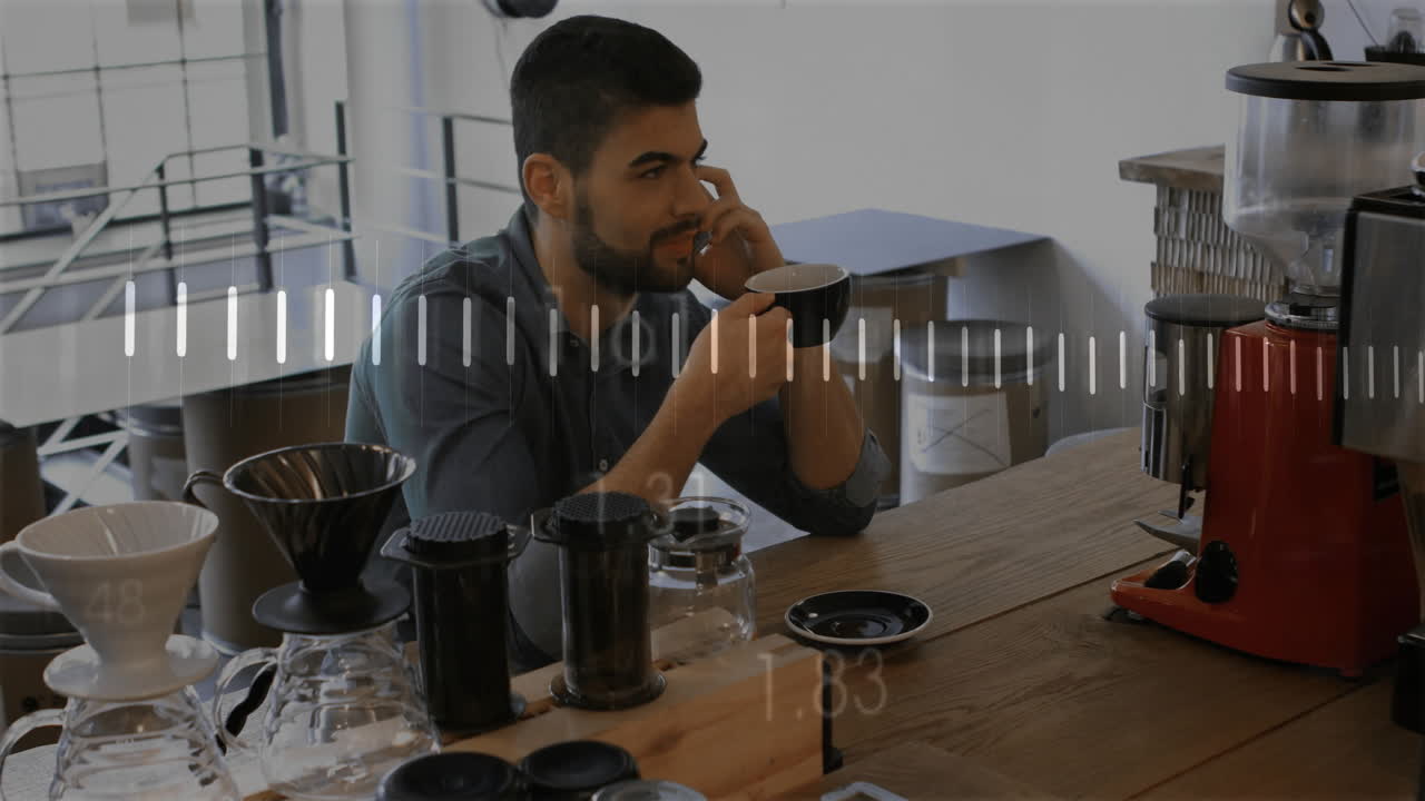 Animazione di diagrammi su uomo d'affari birazziale che parla al telefono