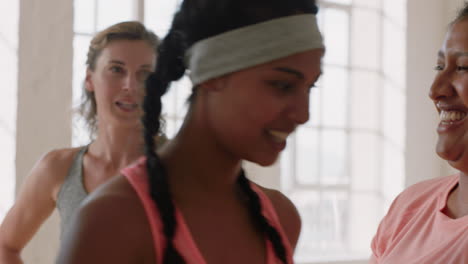 beautiful young women in dance class friends having fun chatting enjoying healthy fitness lifestyle resting after intense dancing practice workout in studio
