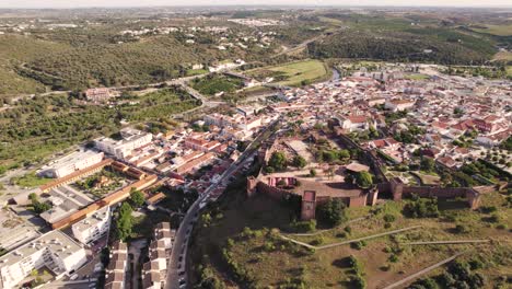 Aerial-panoramic-above-Imposing-Castle-of-Silves,-Algarve,-Portugal