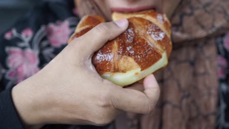 woman eating a croissant