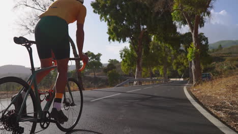 a man is cycling on a road bike, embracing outdoor exercise on a deserted morning road. the notion of extreme sports is captured with finesse in slow motion