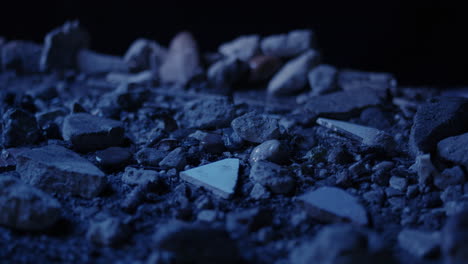 thunderstorm with heavy lightning rain pouring on rocky debris surface close-up smooth macro dolly shot