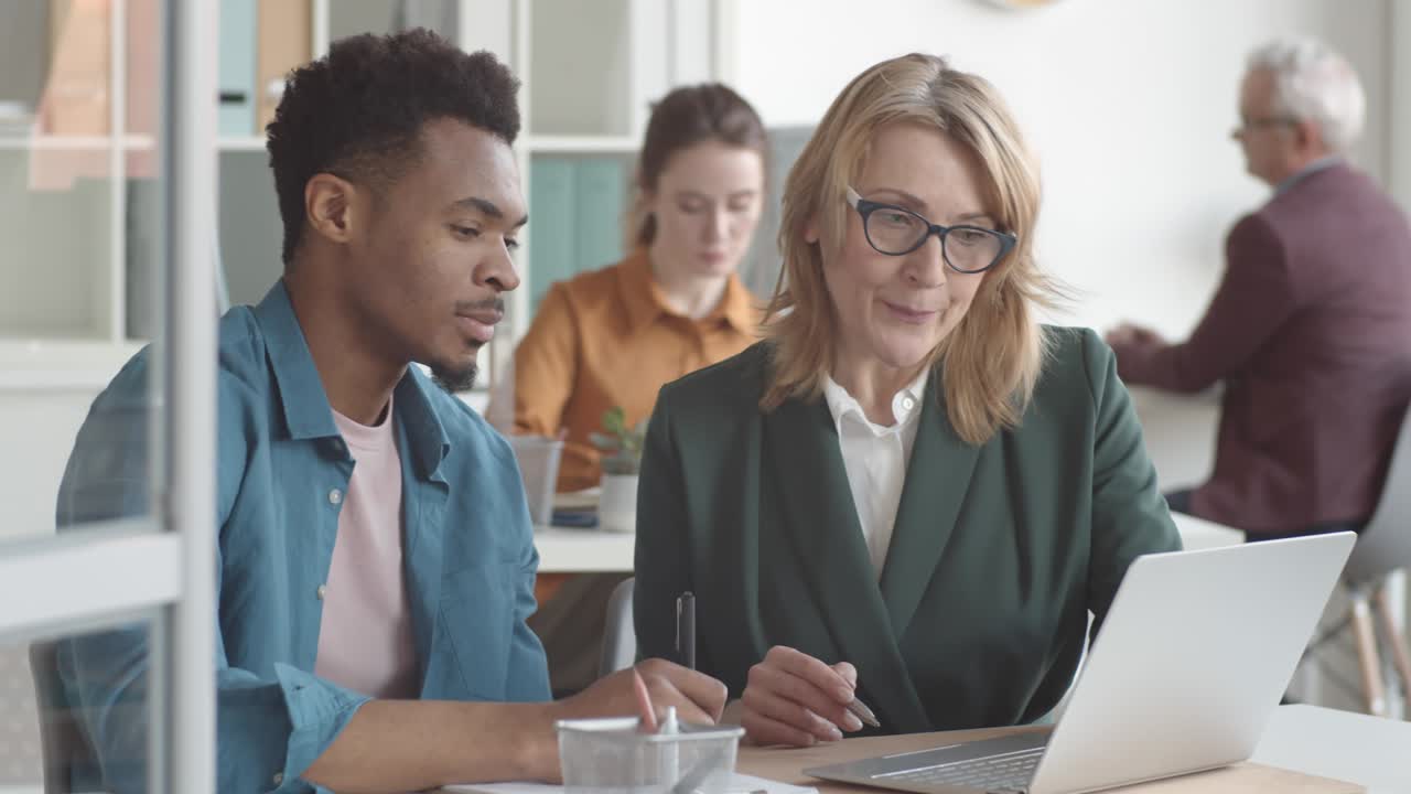Young Afro-American Man Learning Duties on First Day at New Job in Office