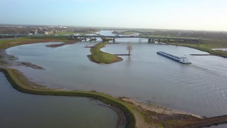 drone-footage-of-the-boat-approaching-the-bridge-in-4K-in-Holland