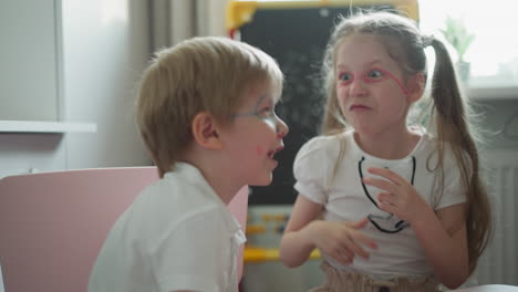 couple of cheerful children laughs and makes funny faces