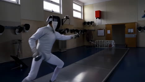 a fencer performing a lunge during a training session