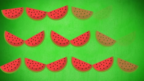 Animation-of-single-watermelons-floating-on-green-background