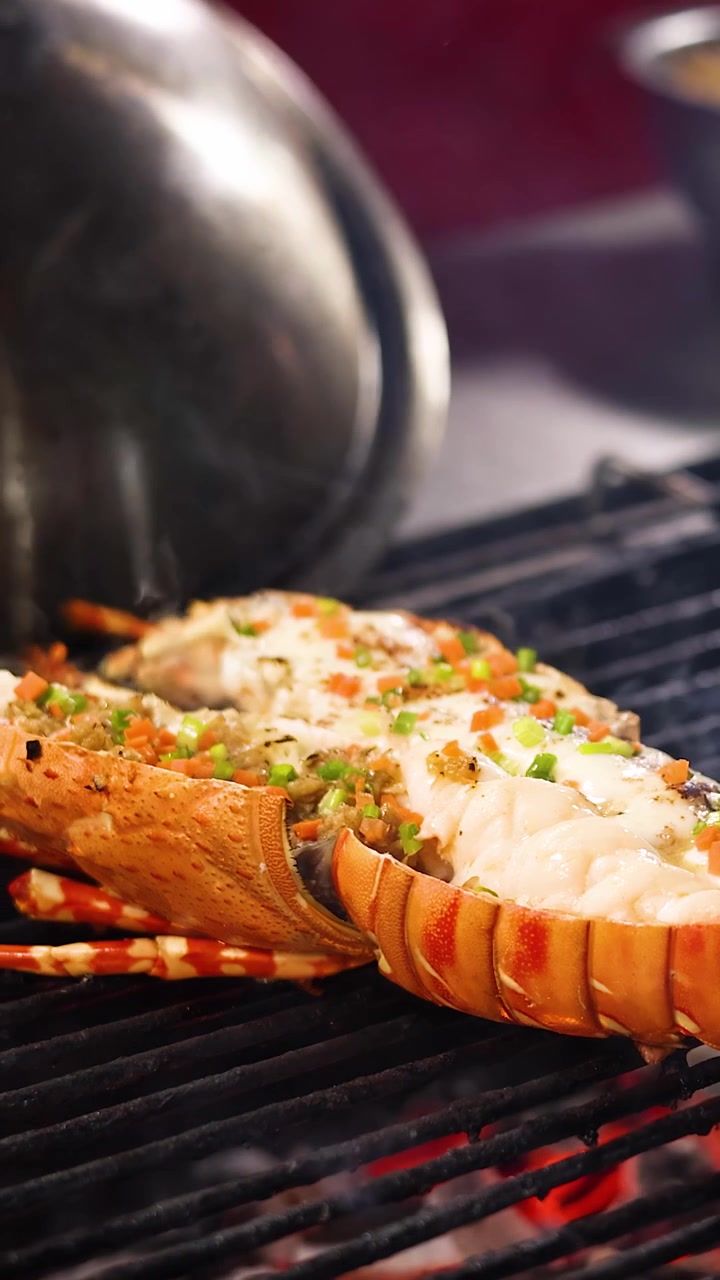 Lobster tail grilling over open flame, garnished with herbs, vibrant street food night market lighting