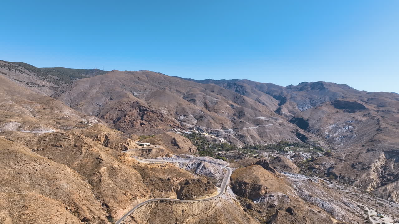Aerial across the burgeoning flanks of Almeria's Sierra Alhamilla mountain Spain