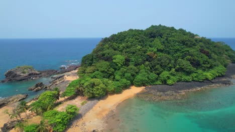 aerial view flying backwards in a circular shape at ilheu bom bom and bom bom beach at ilha do principe, sao tome,africa