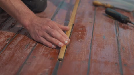 test fitting wooden insert repairing planked roof on boat