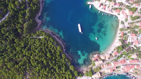 retreating overhead drone shot of a secret beach getaway known to a few people as agriosiko beach, located in the island of cephalonia, situated in western greece