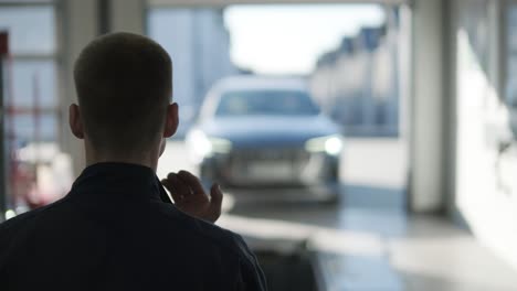 mechanic performing a wheel alignment process in a modern workshop. professional equipment is used to ensure accurate vehicle alignment for optimal performance and safety