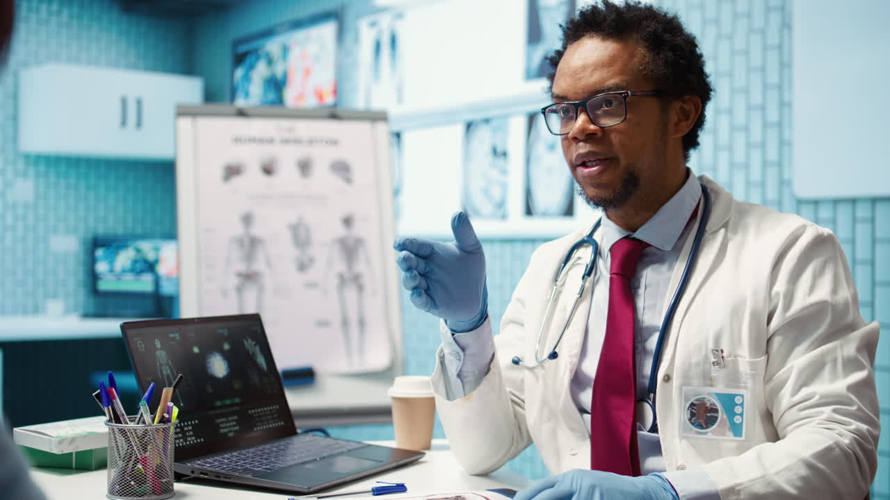 African american medic putting on his rubber gloves and showing heart shape sign