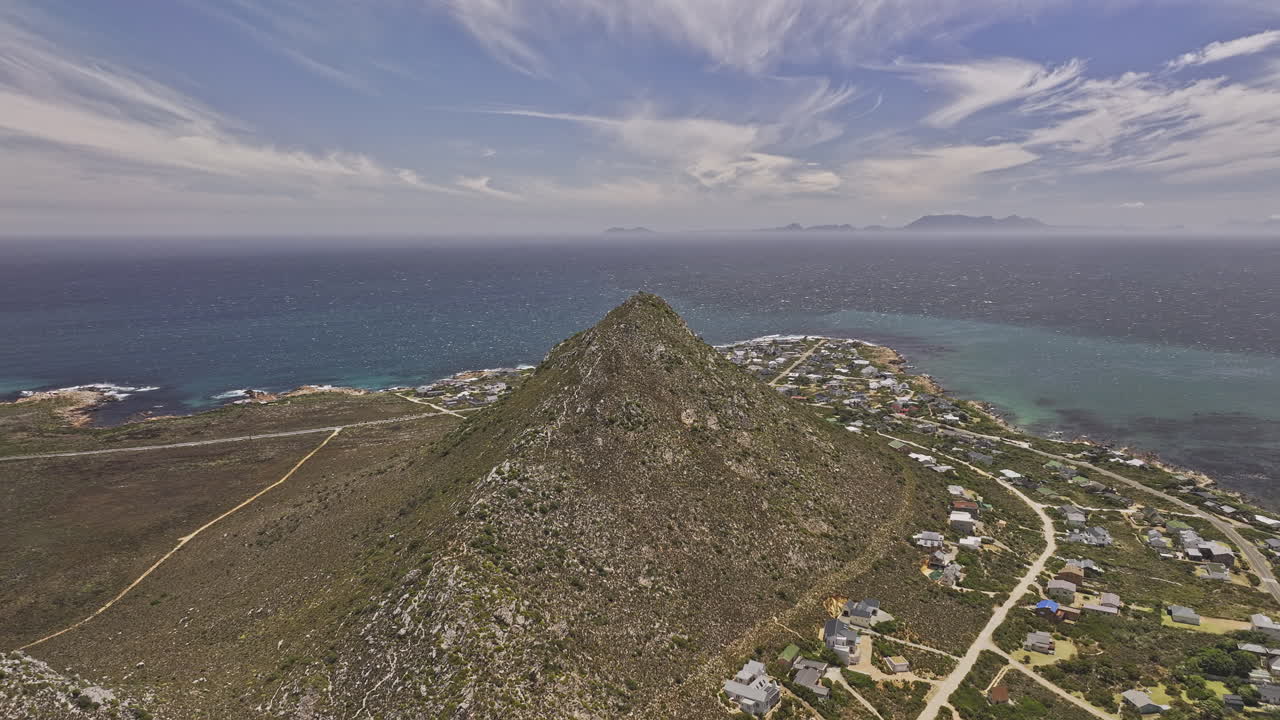 Pringle Bay South Africa Aerial v1 high flyover Hangklip summit capturing breathtaking views of foothill coastal village, mountain terrain, and False Bay - Shot with Mavic 3 Pro Cine - Jan 9th 2024