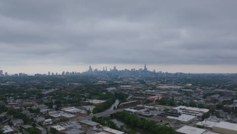 aerial view of a city skyline with urban landscape and river on an overcast day
