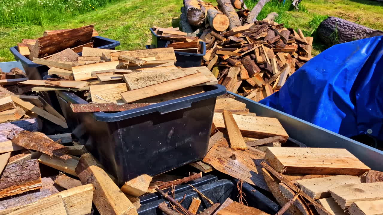 Split Firewood and Plastic Crates Loaded on Trailer in Sunny Countryside