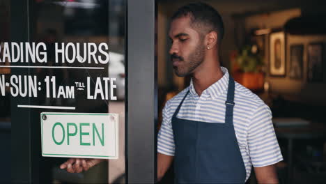 man in apron at the store entrance