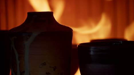 ceramic vases and cups by fireplace