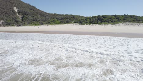 Aerial-View-Of-Waves-Crashing-To-The-Sandy-Coastline-Of-Zenith-Beach-In-Tomaree-National-Park-In-NSW,-Australia