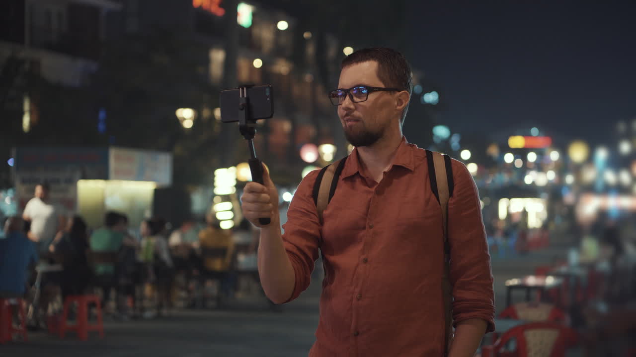 Man vlogging at a night market