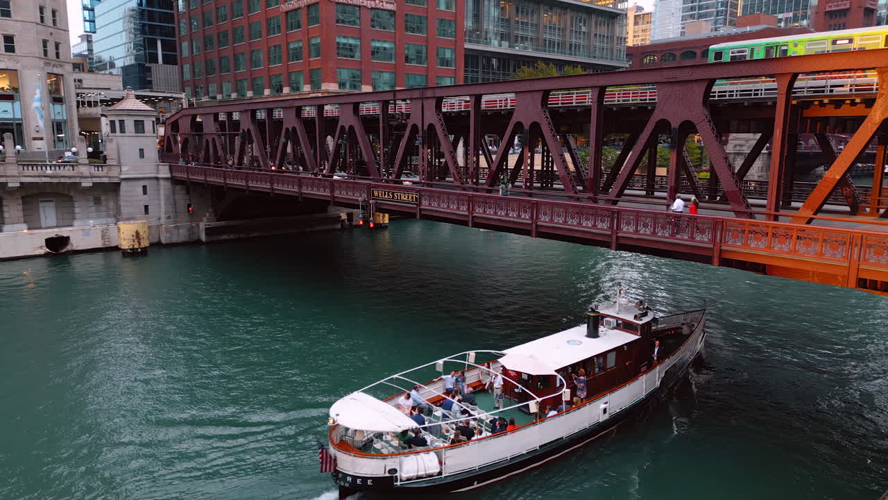 Chicago, USA, 29 June 2025: People travel on the river boat by the Chicago River and go under the bridge. Transport and pedestrians move by the bridge