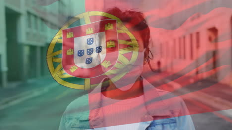 animation of flag of portugal waving over woman wearing face mask during covid 19 pandemic