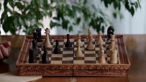 fast pace time-lapse of a game of chess played on a vintage wooden board