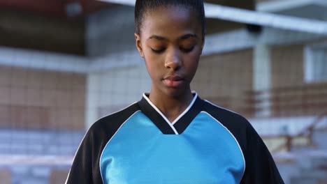 female player holding volleyball in the court 4k