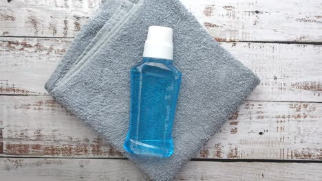 blue mouthwash bottle on grey towel