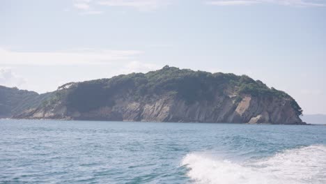 tomogashima island, viewed from departing boat crossing seto inland sea, japan