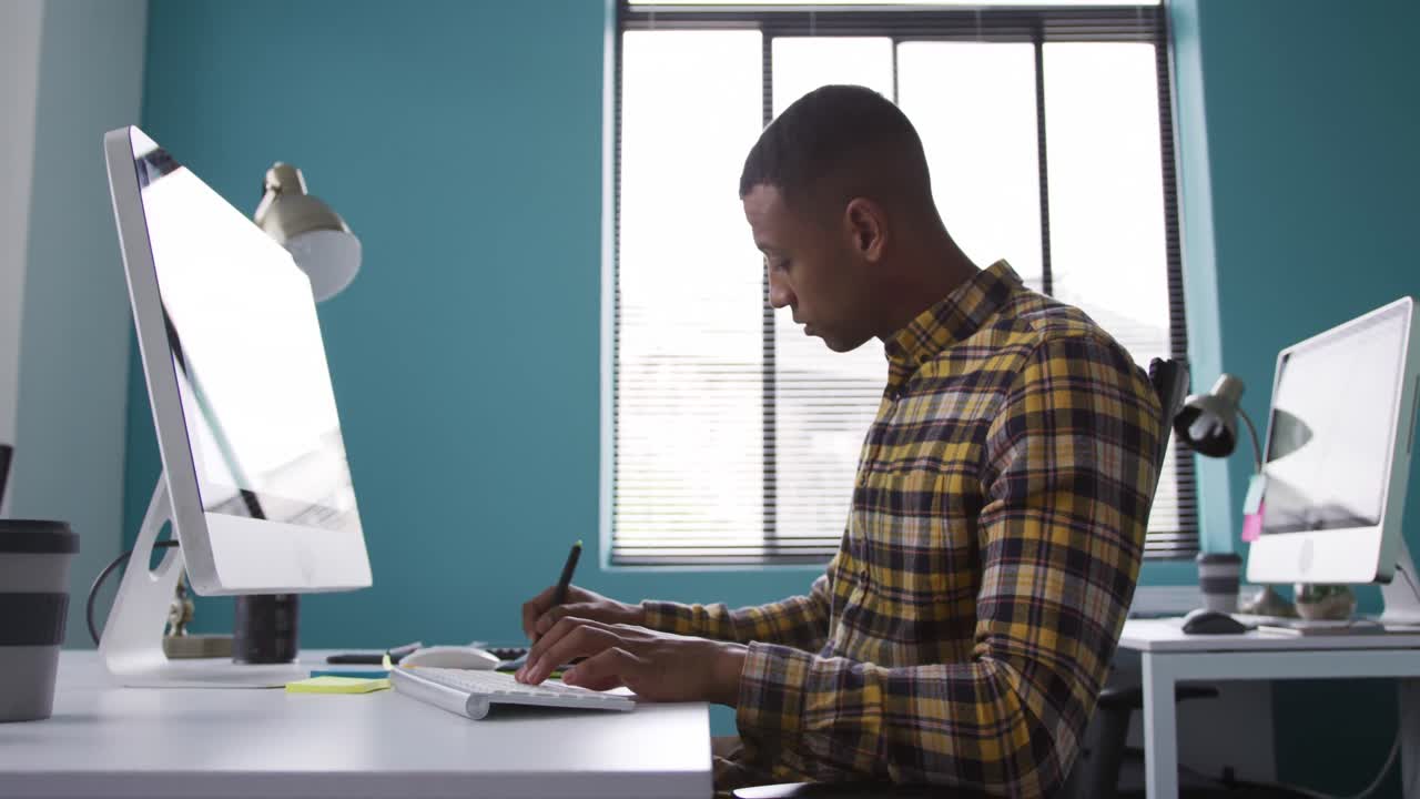 Mixed race man working on computer