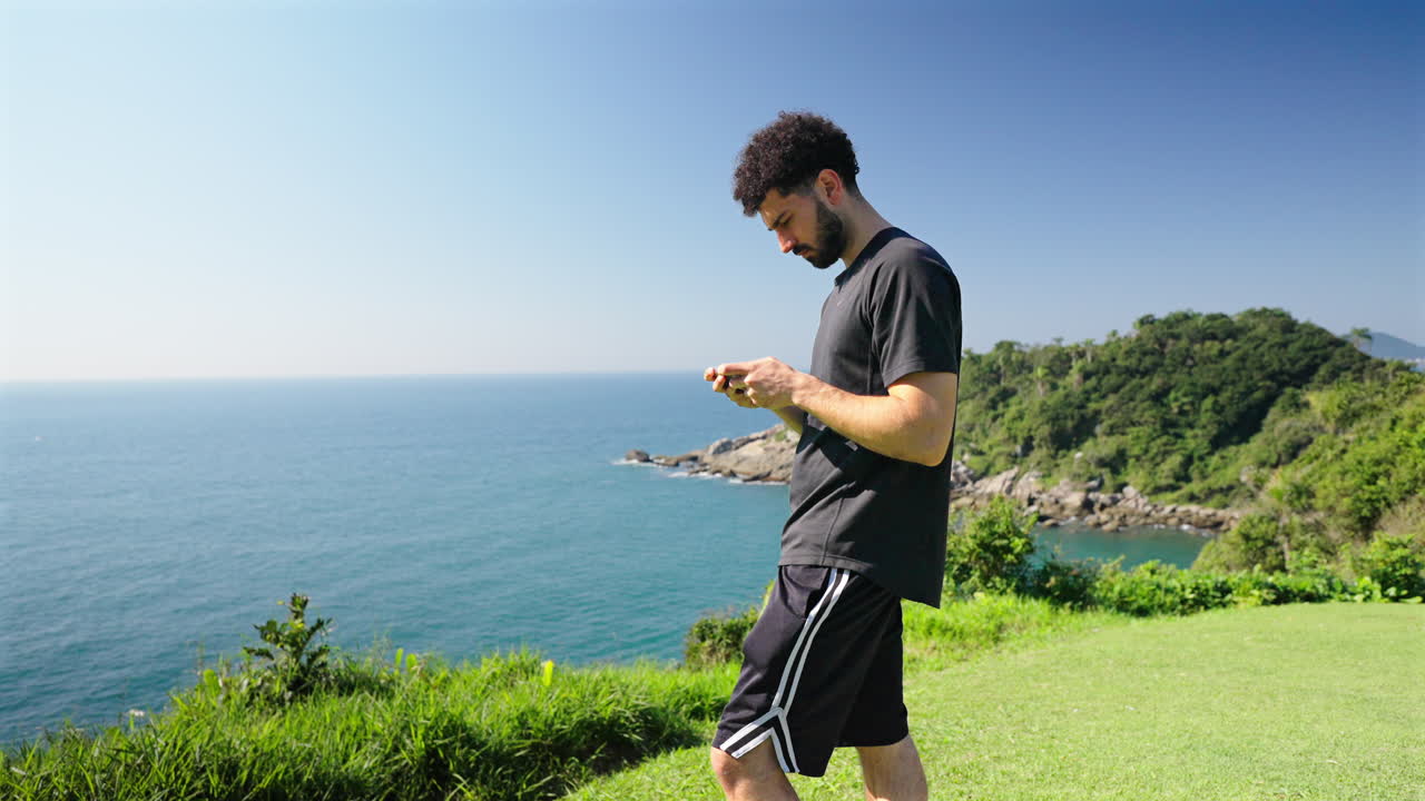 Digital nomad typing on smartphone near Brazil coast, lifestyle and social media content