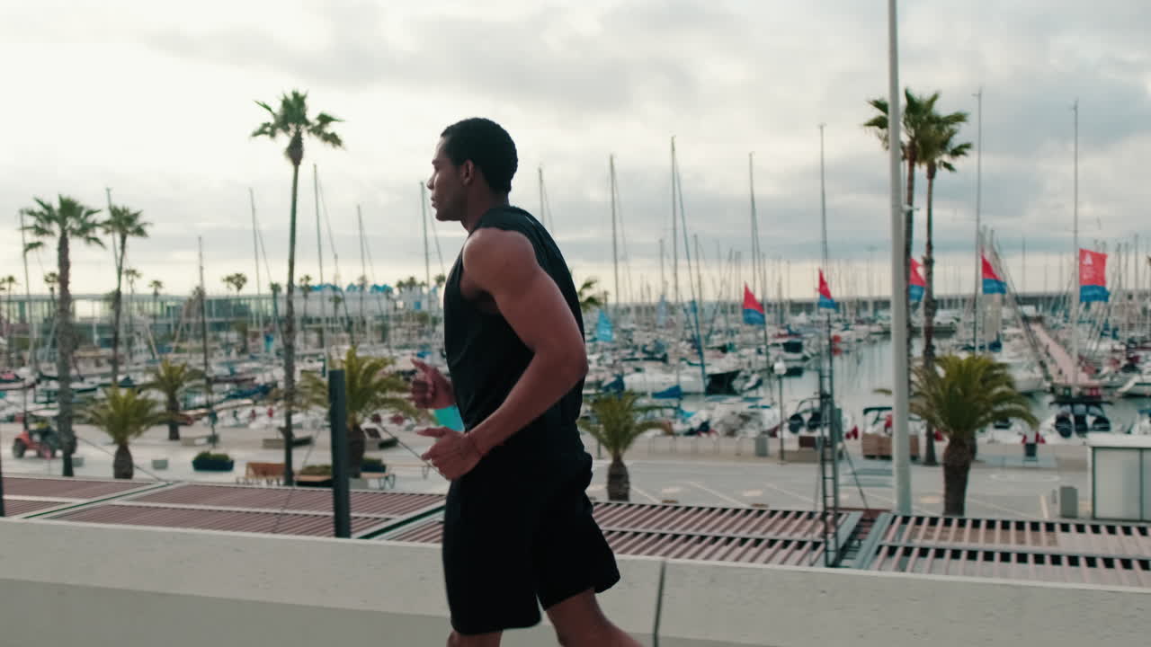 Fit Man Runs Along The Marina Harbor