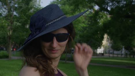 Lady-with-blue-hat-and-glasses-making-eye-contact-and-calling-you-with-her-finger