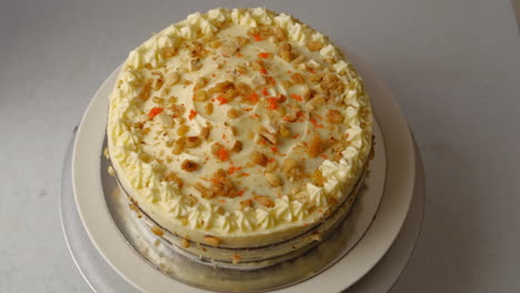 tempting carrot walnut cake on a rotating cake stand, top view, studio shot