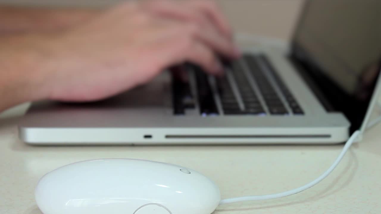 Man'S Hands Working A Laptop Keyboard And Mouse Looking