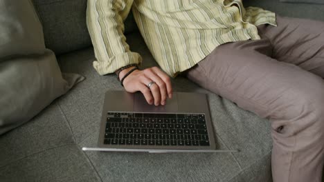 man working on laptop and talking on phone